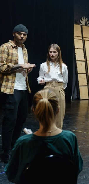 theater stage with 3 people