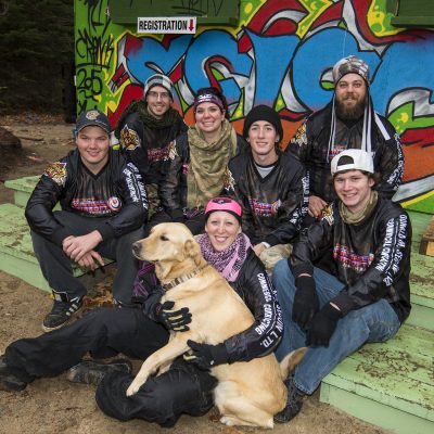 a group of people posing for a picture in paintball gear