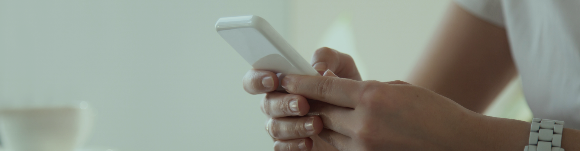 hand holding a white phone
