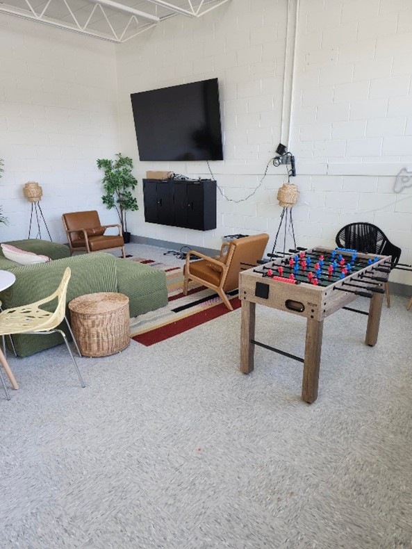 Photo of lounge space with comfy chairs and foosball table