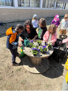 Photo of students and a teacher gardening