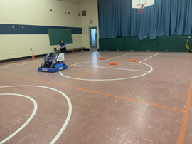 Photo of a student on a robot at the Robotics & Parent Engagement STEM event.